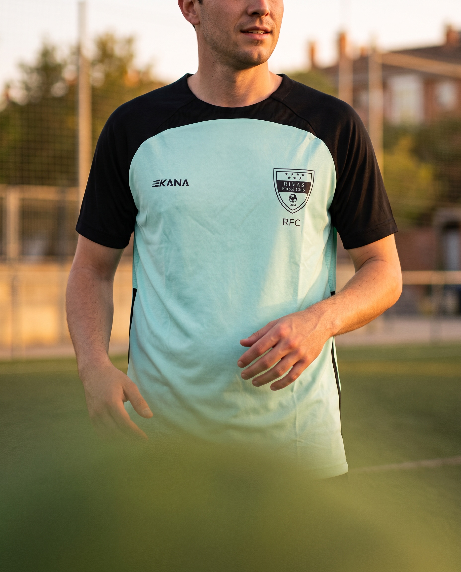 A man in a club shirt on a pitch